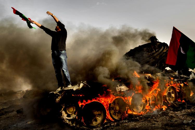 Franske NATO-fly bomber Gaddafi-tro styrker i Ajdabiya den 26. marts 2011. En lokal mand takker Gud for sejren. 