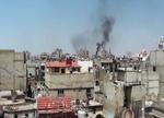 fronten. Kampene fortsætter i Syrien. Billedet viser angiveligt røg fra granatnedslag i byen Homs mandag, men nyhedsbureauet AP gør opmærksom på, at det ikke kan bekræfte billedets autencitet. 