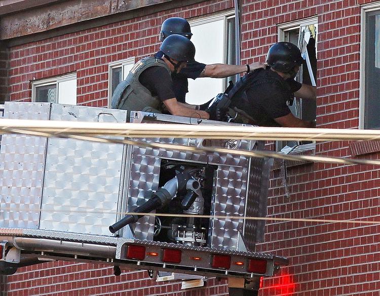 Massakre. Politiet brugte et kamera til at kigge ind i den mistænkte bag 'Batman-massakren' lejlighed, der var fyldt med sprængstof og bombefælder. 