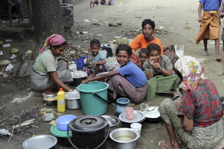 flugt. Nogle af de muslimske flygtninge får sig et måltid i Thechaung-lejren i den vestlige del af Myanmar. 