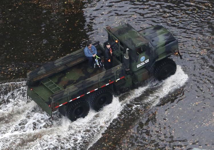 Et militærkøretøj på vej gennem vandmasserne. 
