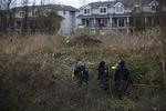 Eftersøgning. Politiet går igennem højt græs på Staten Island, der har været helt dækket af vand. 
