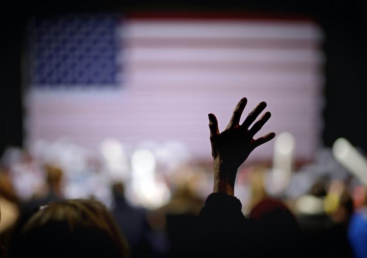 En tilhænger af Mitt Romney nøjest med at strække en hånd i vejret ved valgmøde i Virginia Beach. 