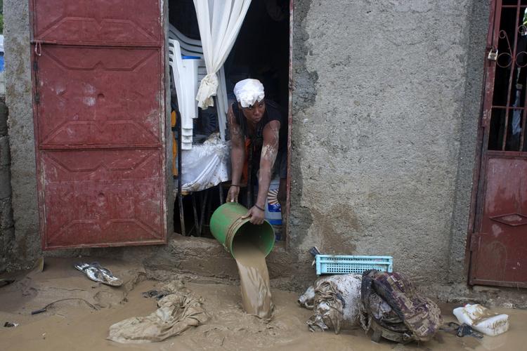 Oversvømmet. En indbygger i Port-au-Prince hælder mudder ud af sit hjem efter et besøg fra Sandy. Problemerne er kun lige begyndt for det caribiske land. 