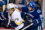 næstbedst. Jannik Hansen (th) sender Nashville Predators' Sergei Kostitsyn en tur i banden under nattens kamp i NHL. 