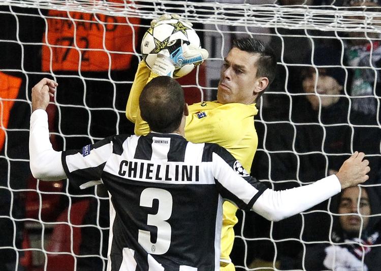 udlængsel. FC Nordsjællands keeper,  Jesper Hansen, sikrer sig bolden foran Juventus' Giorgio Chiellini i den uafgjorte Champions League-kamp i Parken. 