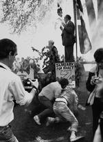1986: Mogens Glistrup taler i Fælledparken 1. maj mens moddemonstranter anholdes af politiet. 