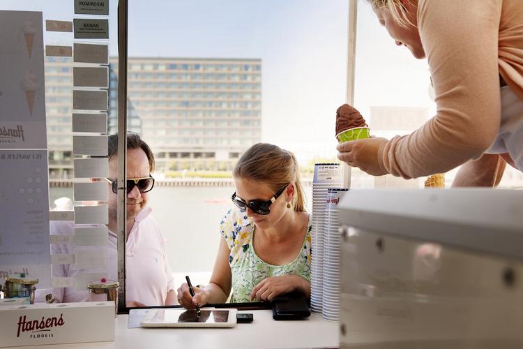 mens vi venter. Indtil de store fælles mobilbetalingsløsninger som den fra Nets bliver en realitet, har flere alternative løsninger set dagens lys. Her er det en lille kortlæser, som isbilen på Islands Brygge har installeret i en smartphone. Kunderne skal så bare køre deres dankort igennem og indtaste pinkoden for at betale for isen. 
