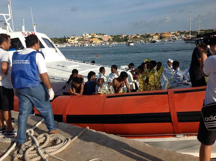 REDNING. Italiensk redningsbåd ankommer til Lampedusa med nogle af de overlevende fra nattens forlis. 