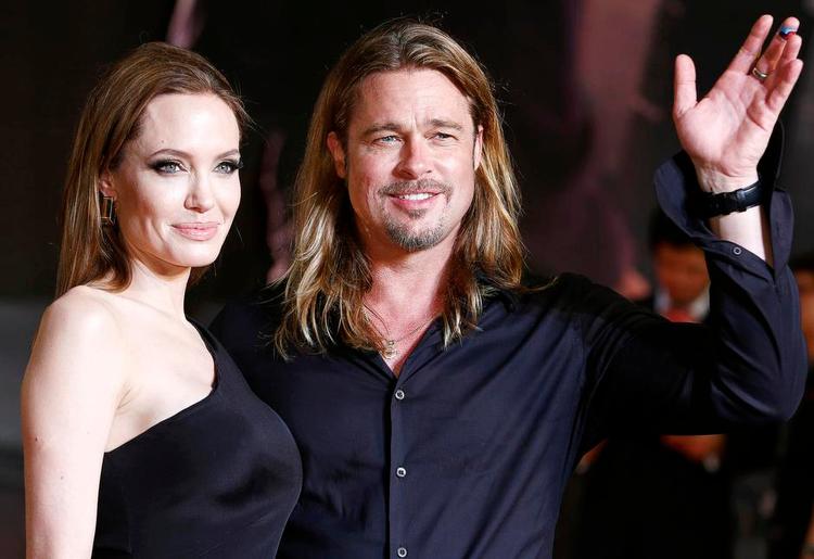 Stjernekram. Brad Pitt med sin hustru Angelina Jolie vinker til fans ved premieren på filmen 'World War Z' i Tokyo i juli. 