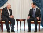 Udmelding. Bashar al-Assad (til højre), som her taler med Irans udenrigsminister, Mohammad Javad Zarif, har ikke tænkt sig at forlade sin post. 