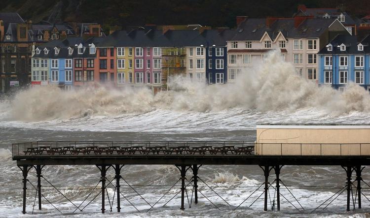 Storm. Bølger rammer promenaden i Aberystwyth, Wales. 
