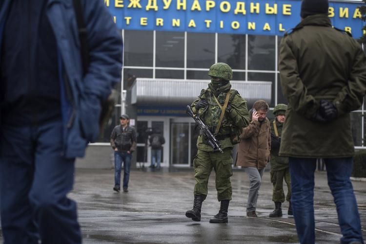Bevogtning. En uidentificeret bevæbnet mand holder vagt foran den civile lufthavn i Simferol på Krim-halvøen i Ukraine, der i nat blev indtaget af bevæbnede mænd, som dog senere forlod lufthavnen igen. 