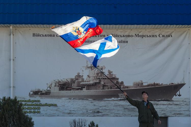 Krim. En prorussisk demonstrant svinger med det russiske flag foran den ukrainske flådes hovedkvarter i Sevastopol på Krim. Netop 'Sevastopol' bliver navnet på et af de to franske krigsskibe, som russerne har købt. 