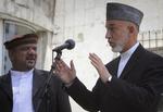 Dødsfald. Mohammad Qasim Fahim (til venstre) ses her sammen med Hamid Karzai, der sørger over sin vicepræsidents død. 