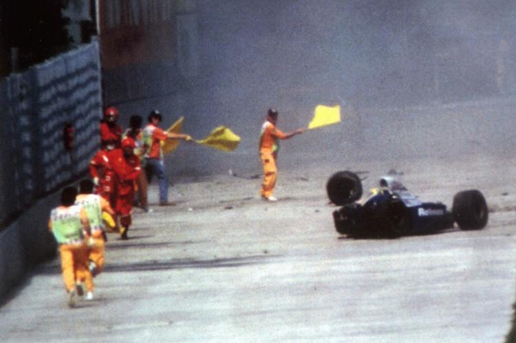 forbedringer. Sikkerhedsfolk på Imola-banen forsøger i 1994 at advare de andre kørere om det voldsomme uheld, Ayrton Senna netop havde været involveret i. 