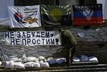 Modstand. En pro-russisk militant hejser et banner med teksten 'Glem ikke - tilgiv ikke' i centrum af byen Slavjansk, hvor der skal være afstemning om selvstændighed. 