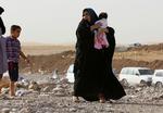 FLYGTNINGE. Mosul-indbyggere ankommer til Khazir-lejren ved Irbil efter Isis' erobring af deres hjemby. 