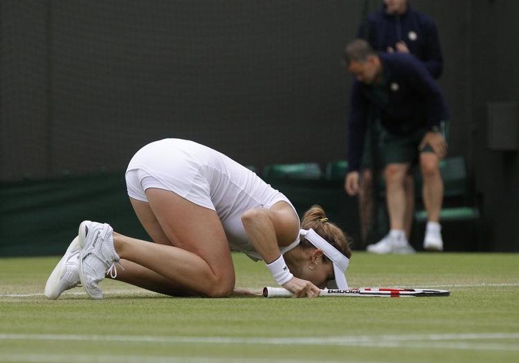 Franske Alizé Cornet kysser græsset, efter hun har besejret Serena Williams og har spillet sig videre til 1/8-finalen. 