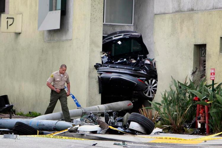 kløvet. Her i væggen har bagpartiet af en Tesla klemt sig fast efter en voldsom ulykke. Fronten af bilen ligger et par hundrede meter væk. 