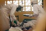 Behandler. På dette billede ses lægen Kent Brantly (til venstre) i færd med at behandle en patient for ebola på et hospital i Liberias hovedstad, Monrovia, inden han selv blev smittet med virussen og nu er under behandling. 