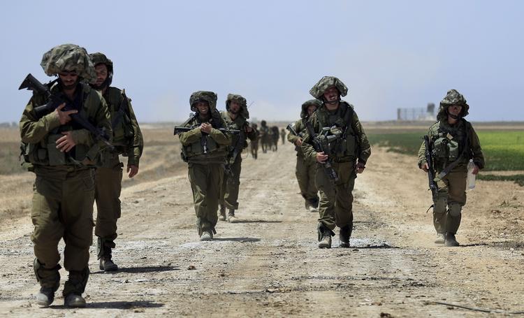 kamp. Israelske soldater vender tilbage til Israel efter kampe o Khan Younis i Gaza-striben. 