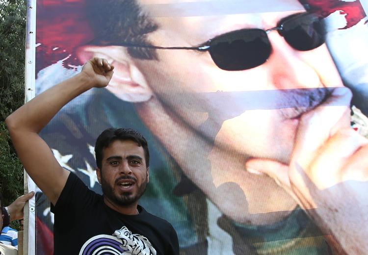 Leder. Syriens præsident Bashar al-Assad har nægtet ethvert ansvar for sidste års angreb med giftgas på forstæder til hovedstaden Damaskus. 1.000 blev gasset ihjel. (arkivfoto) 