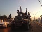 Fremmarch: Styrker fra den ekstremistiske organistion IS kører gennem Mosul i det nordlige Irak i slutningen af juni. 