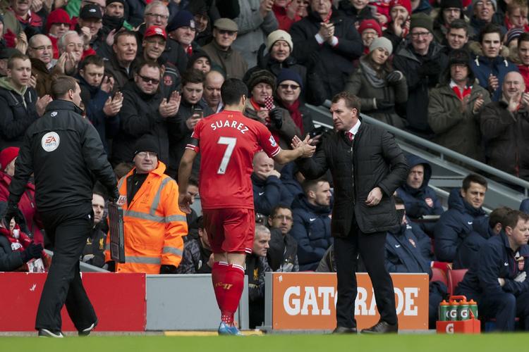 solgt. Brendan Rodgers (th) fik Luis Suarez (tv) tilbage på ret køl efter flere episoder og karantæner, men så bed angriberen en modstander under VM i Brasilien. 