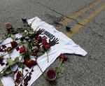 KONGRONTATION. Blomster og en t-shirt lå efter drabet på Michael Brown midt på Canfield Drive i Ferguson som et minde om det blodige møde. 