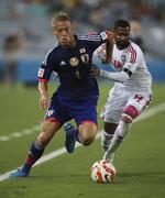Ude. Keisuke Honda (tv) og Japan er færdige ved Asian Cup, som Japan ellers har vundet fire af de seneste seks udgaver af. 