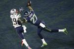 Seattle Seahawks Tharold Simon bryder en aflevering til New England Patriots Brandon LaFel. 