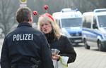 AFSPÆRRING. En kvinde, der var klar til at deltage i karnevalsfesten i den nordtyske by, taler med politibetjent om aflysningen. 