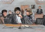 Retssag. Dzhokhar Tsarnaev (i midten) omgivet af sine forsvarsadvokater, heriblandt Judy Clarke til højre. 