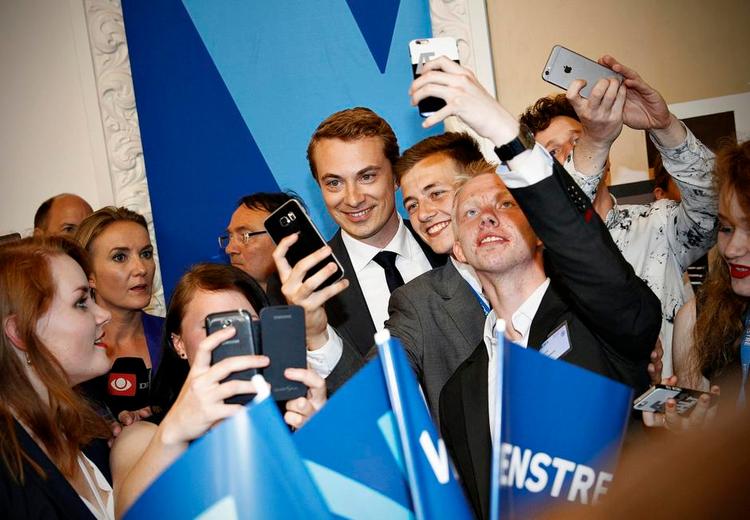 Selfietid. Dansk Folkeparties Morten Messerschmidt omgivet af Venstrefolk på valgaftenen. Nu vil han havde den afgående statsminister til at tage til EU på torsdag og kæmpe for DF's synspunkter. 