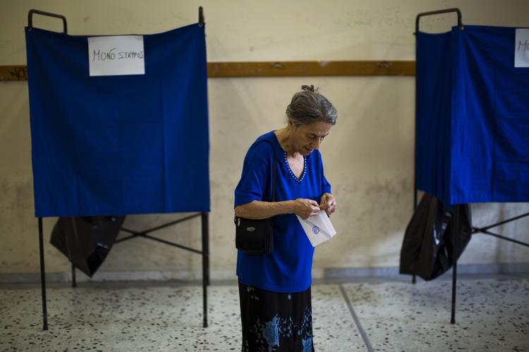 valgdag. En kvinde med sin stemmeseddel, da dagens folkeafstemning om låneaftale for græsk økonomi i dag åbnede i Athen. 