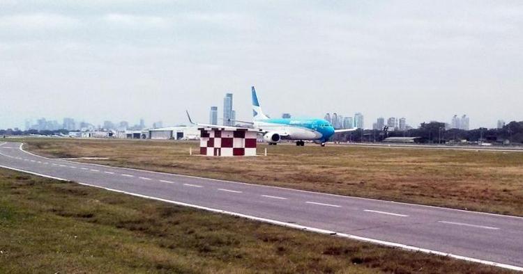 BUENOS AIRES. Den øredøvende larm langs den nordlige kyst i Buenos Aires skyldes - udover det uendelige antal biler - de konstante fly, der letter og lander med høj frekvens. De lokale iagttager maskineriet med bycentrummets højhuse i baggrunden og de utallige stande på den modsatte side af vejen. Læserfoto: Danny Liu 