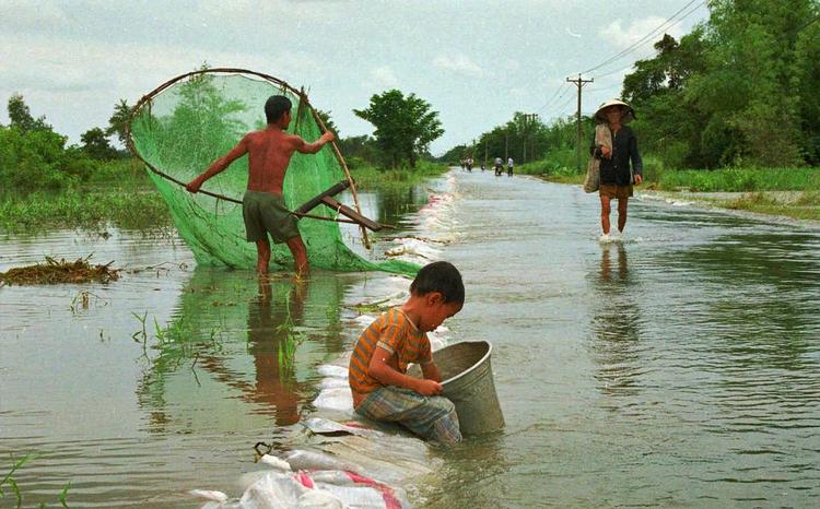 Oversvømmet. Sandsækkene var ikke nok til at holde vandet væk fra vejen, da Mekongfloden gik over sine bredder nær Ho Chi Minh City i Vietnam. 