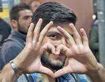 Internationalt. Glade flygtninge og migranter ankommer til München i det sydlige Tyskland. 