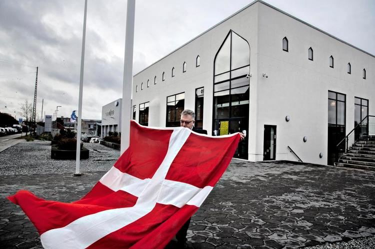 Flagmand. Jehad Al-Farra gør Dannebrog klar foran moskeen på Rovsingsgade i København. Men det er ikke alle, der bryder sig om at se det danske kors foran muslimers hellige bygning. 