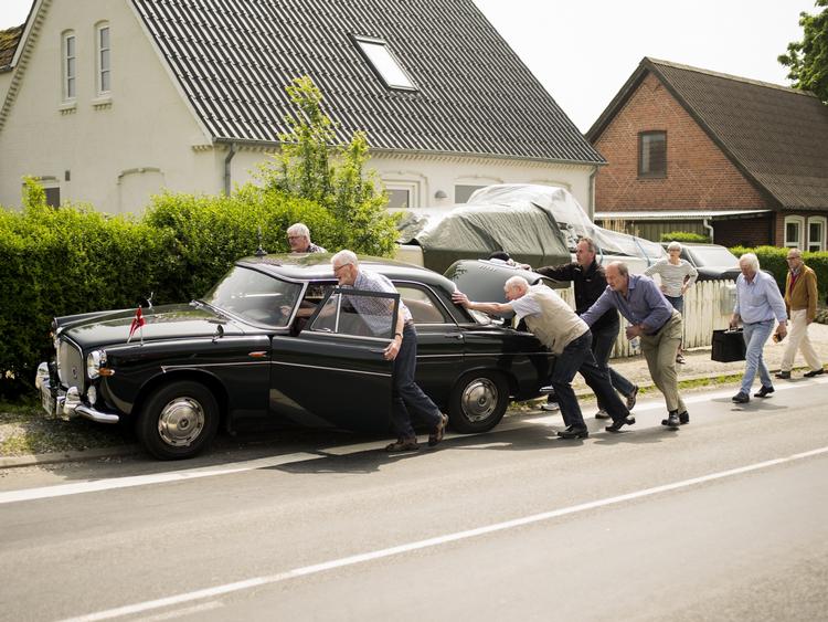 Langeland. Politikens fotojornalistpraktikant, Janus Engel, har tilbragt en måned på Langeland for at dokumentere hverdagslivet på øen. Mennesker hjælper hinanden med at skubbe en bil, der er gået i stå. 