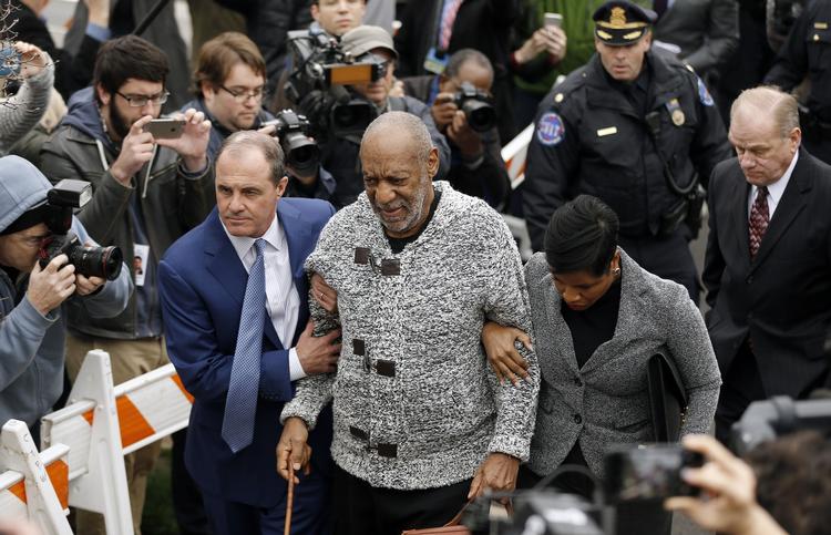 SVAG. Den 78-årige Bill Cosby ankommer med stok til retslokalet i Pennsylvania flankeret af sine to advokater. Her skal han underskrive den kaution på 1 million dollars, som dommeren har fastsat, efter Cosby er blevet sigtet for et seksuelt overgreb på en kvinde i 2004. 