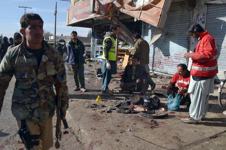 Dræbte. Redningsfolk og politi foran den klinik i Quetta i Pakistan, der blev ramt af et bombeangreb. 