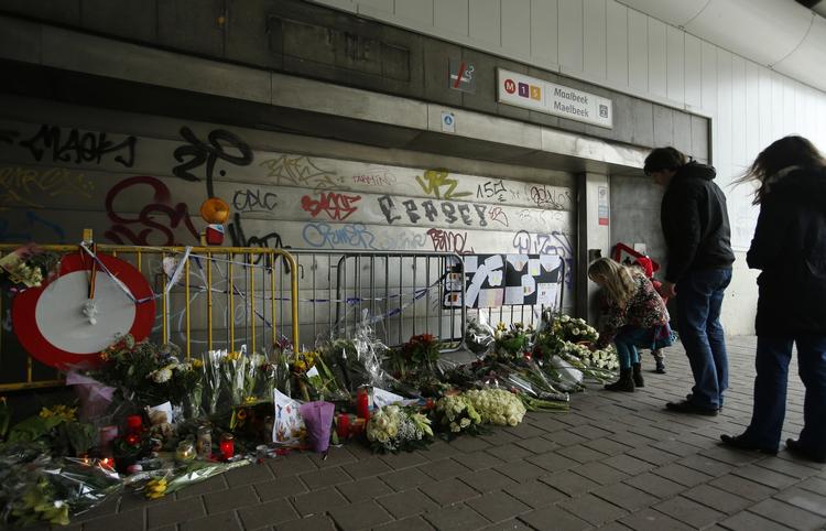 GERNINGSSTED. Bruxelles-boere ser på blomsterbuketter foran Maelbeek-stationen, hvor det ene terrorangreb tirsdag blev gennemført. 