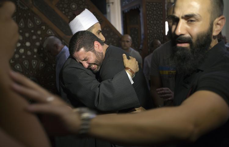 Knust. Imam Samir Abdel Bary trøster filminstruktøren Osman Abu Laban, som mistede fire slægtninge ved flytragedien. Nedstyrtningsstedet i Middelhavet er nu lokaliseret. 