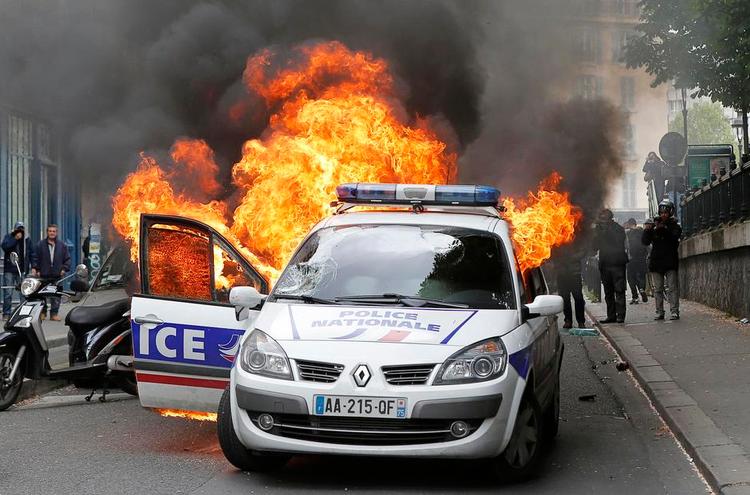 Planlagt? Det lykkedes to politifolk at springe ud af patruljevognen, lige inden den forsvandt helt i flammerne. Meget tyder på, at angrebet var vel for- beredt. 