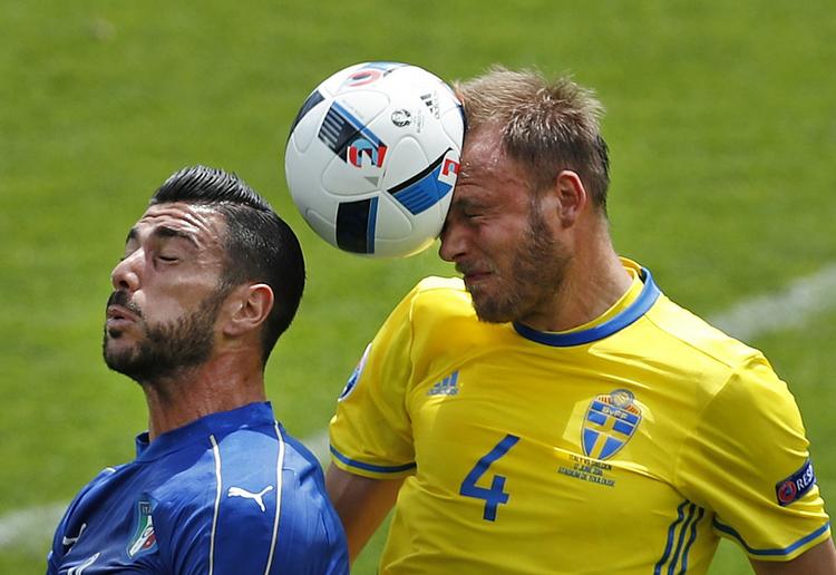 Andreas Granqvist når højest i en duel med Italiens angriber Graziano Pellé. 