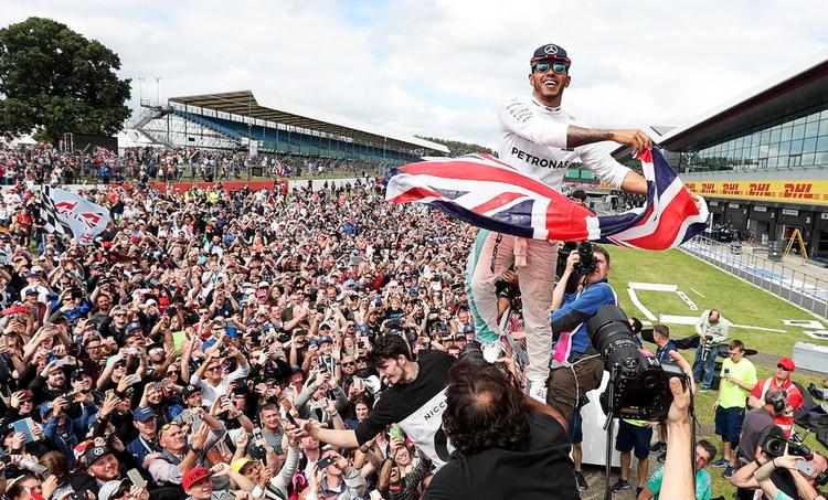 Jubel. En ekstatisk Lewis Hamilton fejrer sin sejr på hjemmebane sammen med de britiske fans. 