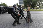 Anholdelse. Billedet er taget i Baton Rouge i staten Lousiana i USA under en demonstration mod politiet i lørdags. Kvinden her ville ikke flytte sig, men stod ubevægelig på vejen, mens de to betjente kom mod hende. 