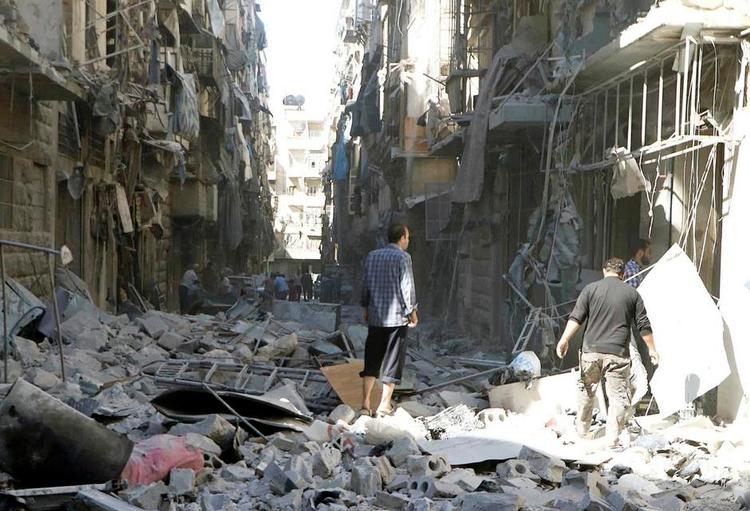Bombet i grus. Redningsfolk fra gruppen ’De hvide hjelme’ undersøger beskadigelserne på beboelsesejendomme efter et af de voldsomste luftangreb. på Aleppo Arkivfoto: Hvide Hjelme/AP 